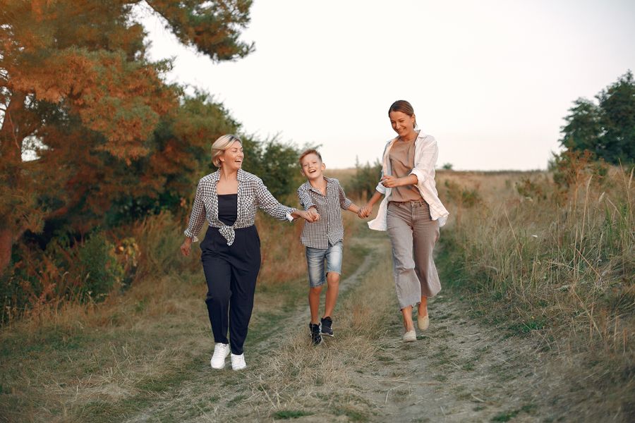 A family of three generations walking together outdoors