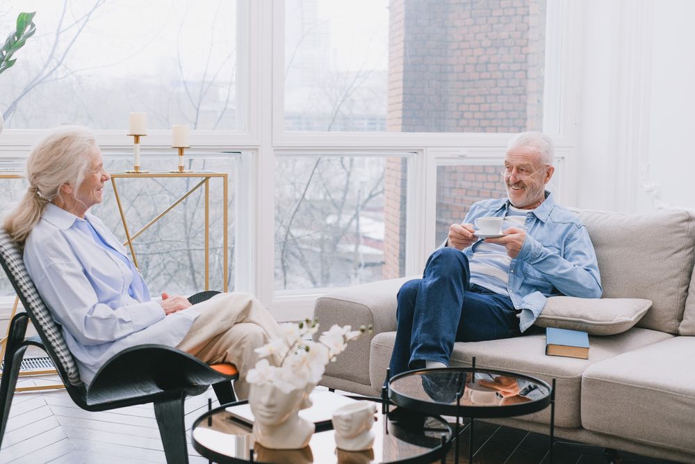 An older couple talking together at home